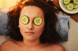 picture of woman relaxing with cucumber slices covering eyes